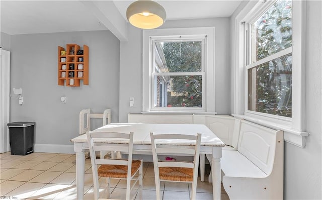 dining area with breakfast area, light tile patterned floors, and a healthy amount of sunlight