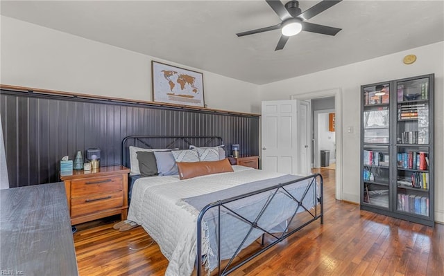 bedroom with dark hardwood / wood-style flooring and ceiling fan