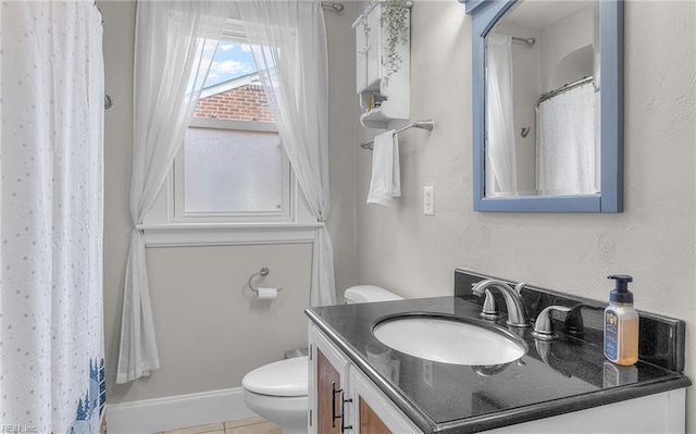 bathroom featuring vanity, tile patterned floors, and toilet