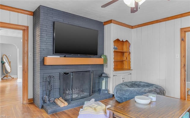 living room with ceiling fan and light hardwood / wood-style flooring