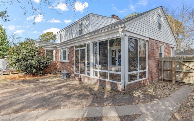 view of side of home featuring a sunroom