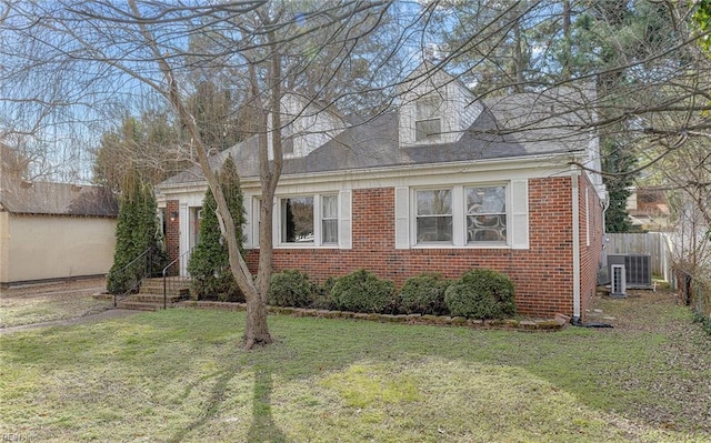 view of front of property with a front lawn and central air condition unit