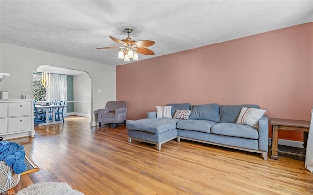 living room featuring ceiling fan and light hardwood / wood-style floors