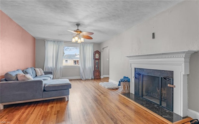 living room featuring ceiling fan and light wood-type flooring