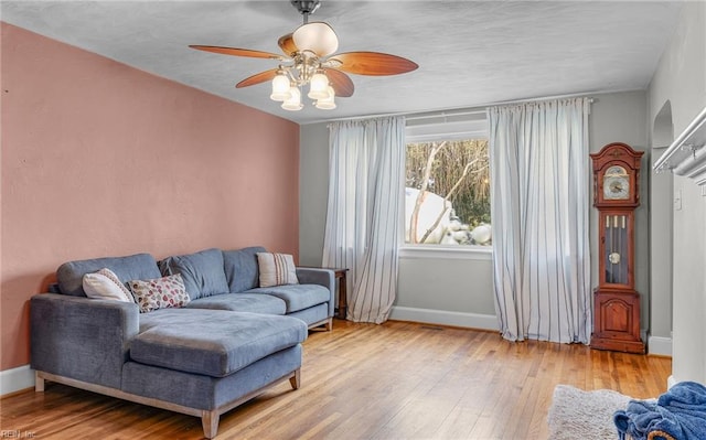 living room featuring ceiling fan and light wood-type flooring