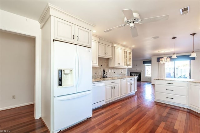 kitchen with sink, white appliances, white cabinetry, tasteful backsplash, and light stone countertops