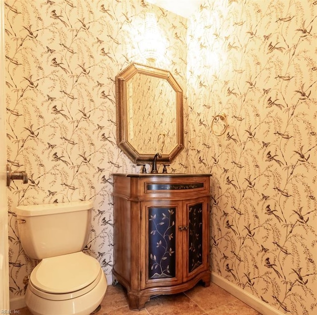 bathroom with vanity, tile patterned flooring, and toilet