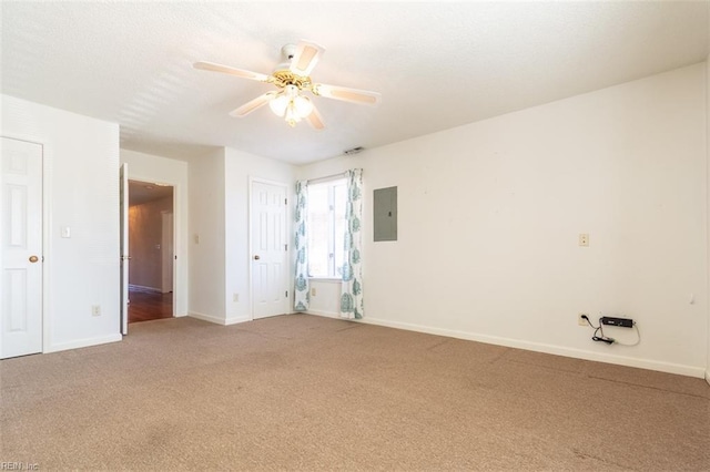 carpeted empty room featuring electric panel and ceiling fan