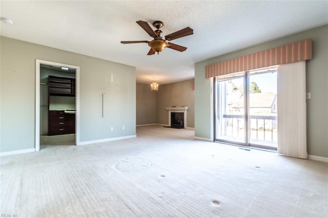 unfurnished living room featuring light colored carpet and ceiling fan with notable chandelier