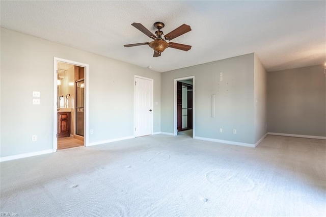 empty room featuring light carpet and ceiling fan