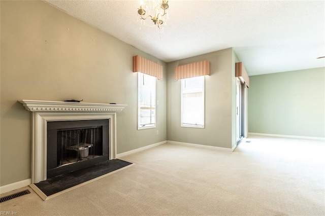 unfurnished living room with a chandelier and light carpet