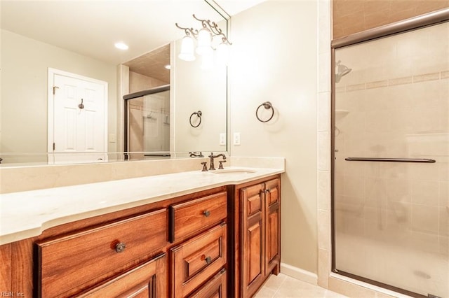 bathroom with tile patterned floors, vanity, and an enclosed shower