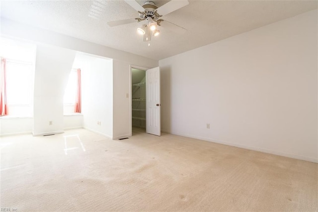 unfurnished bedroom with ceiling fan and light carpet