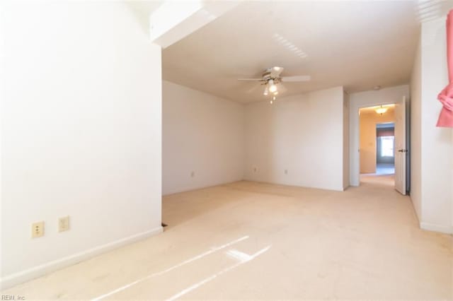 spare room featuring ceiling fan and light colored carpet