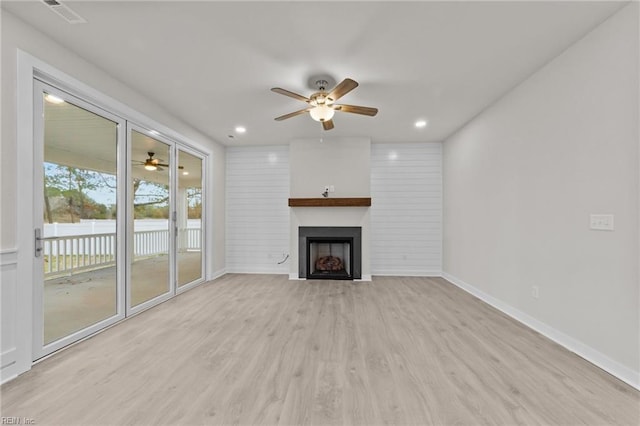 unfurnished living room featuring light hardwood / wood-style flooring and ceiling fan