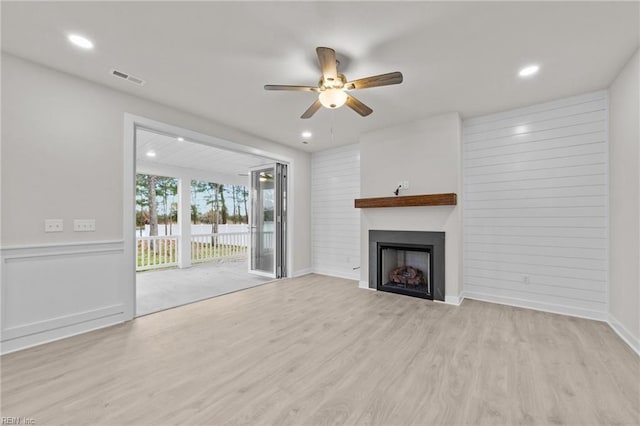 unfurnished living room featuring light hardwood / wood-style floors and ceiling fan