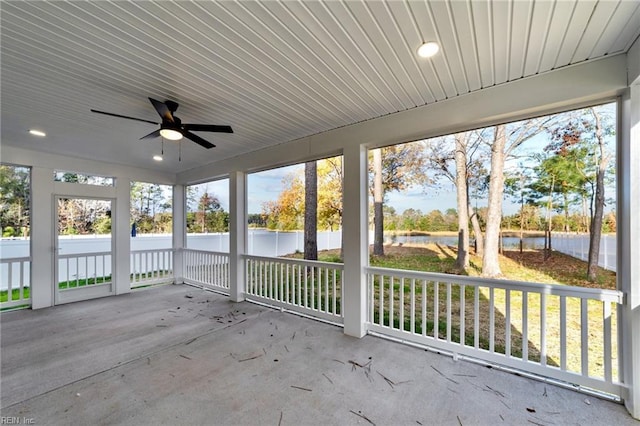 unfurnished sunroom with ceiling fan