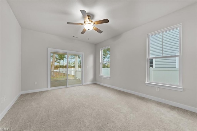 spare room featuring ceiling fan and carpet flooring