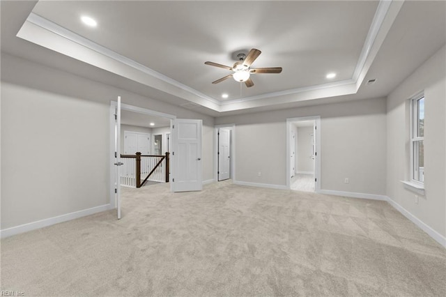 basement featuring ornamental molding, light colored carpet, and ceiling fan