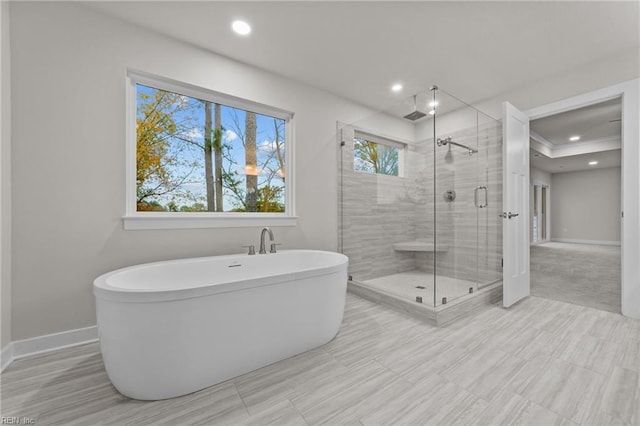 bathroom featuring shower with separate bathtub