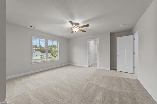 unfurnished room featuring light colored carpet and ceiling fan