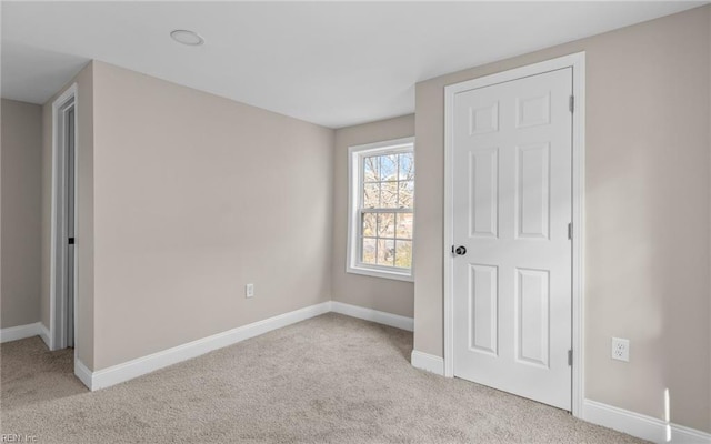 unfurnished bedroom featuring light colored carpet