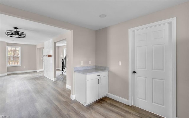 interior space featuring white cabinetry and light hardwood / wood-style floors