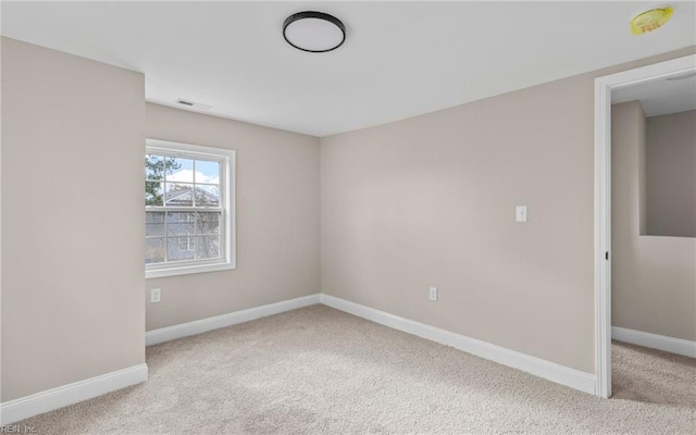 spare room with light colored carpet