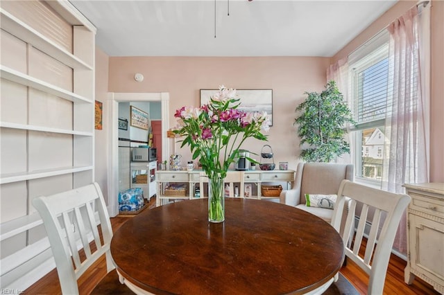 dining space with dark hardwood / wood-style flooring