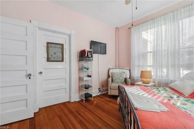 bedroom with ceiling fan and dark hardwood / wood-style flooring