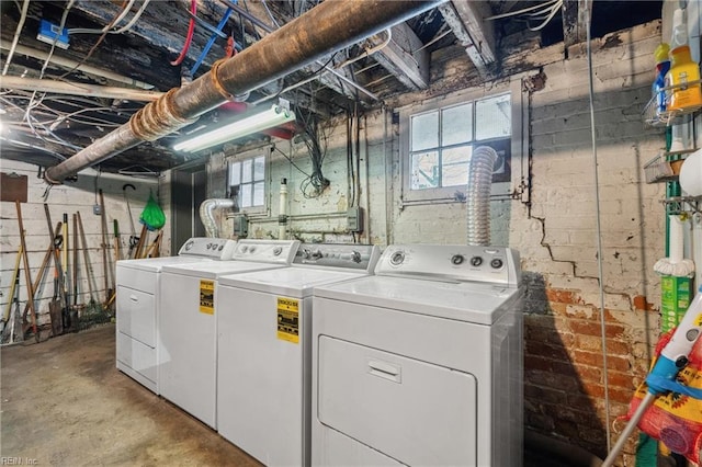 washroom with plenty of natural light and washing machine and clothes dryer