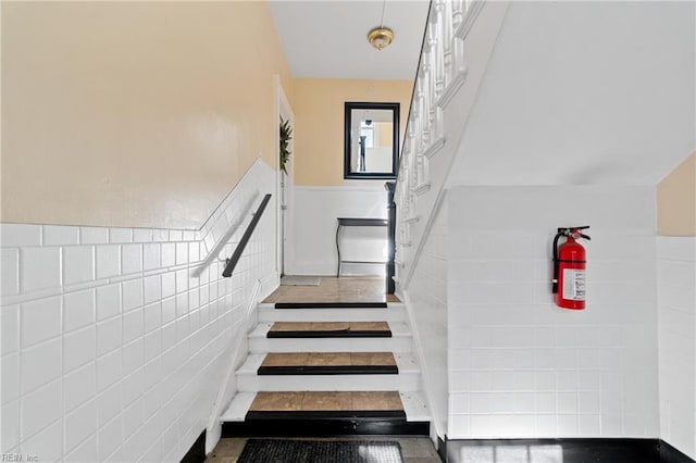 stairs with tile walls