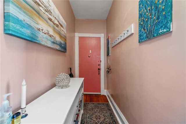 doorway with dark wood-type flooring