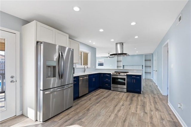 kitchen featuring ventilation hood, white cabinetry, sink, stainless steel appliances, and blue cabinetry