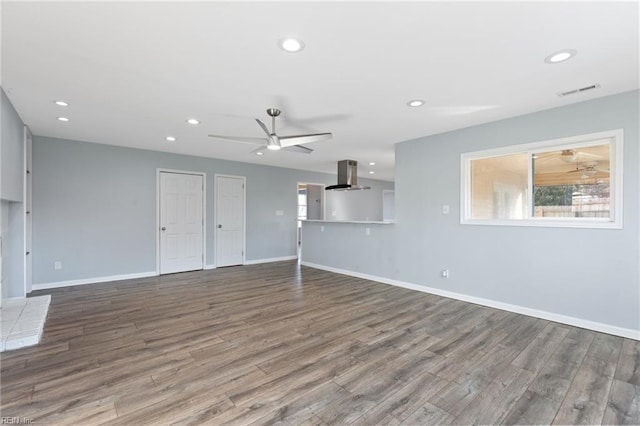 unfurnished living room with ceiling fan and wood-type flooring