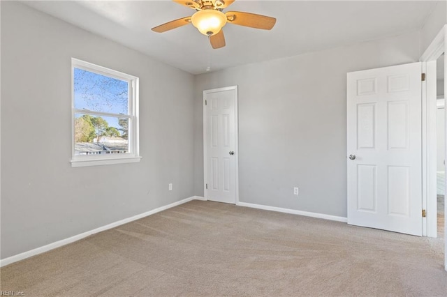 unfurnished room featuring light carpet and ceiling fan