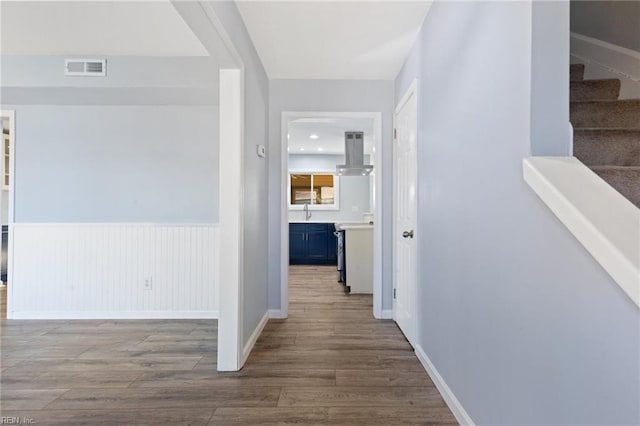 hall with sink and hardwood / wood-style floors