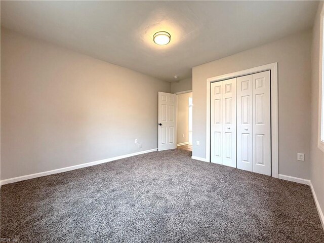 unfurnished bedroom with carpet flooring and a closet