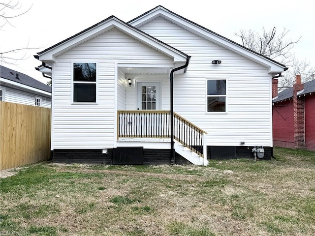 rear view of house with a yard