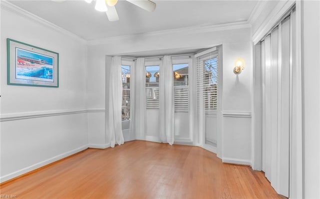 unfurnished room with light hardwood / wood-style flooring, crown molding, and a wealth of natural light