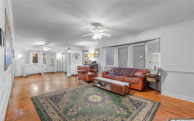 living room featuring ornamental molding, hardwood / wood-style floors, and ceiling fan