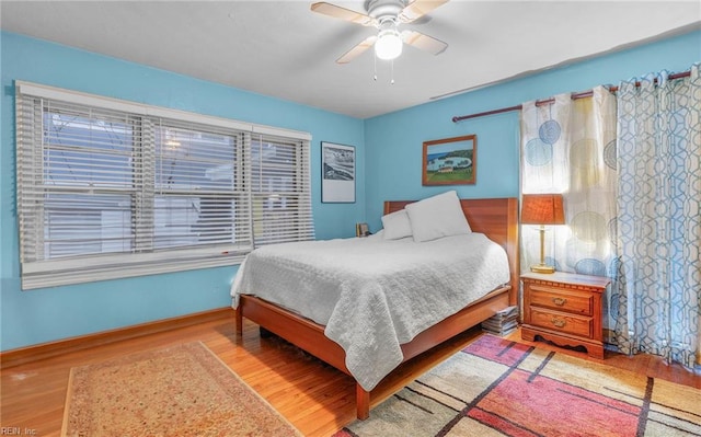 bedroom featuring hardwood / wood-style flooring and ceiling fan