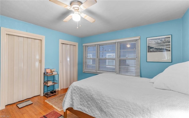 bedroom with light hardwood / wood-style floors and ceiling fan