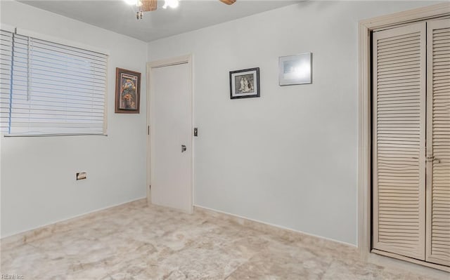 empty room featuring light carpet and ceiling fan