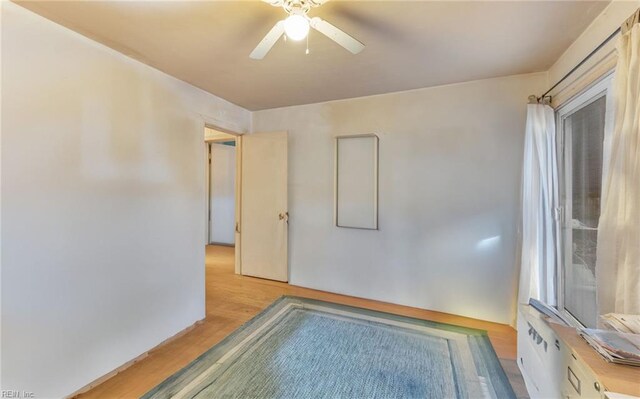 empty room with ceiling fan and light wood-type flooring