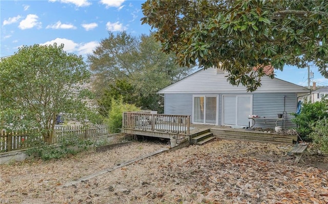 rear view of property featuring a wooden deck