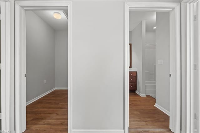 hallway with hardwood / wood-style flooring