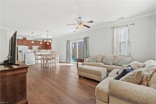 living room featuring crown molding, ceiling fan, and dark hardwood / wood-style flooring