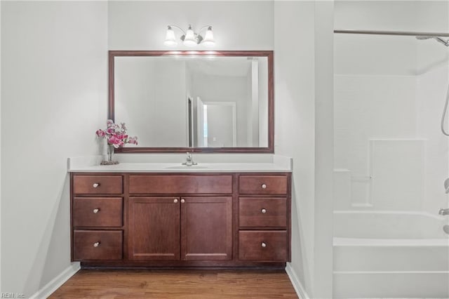 bathroom with vanity, hardwood / wood-style flooring, and shower / bath combination