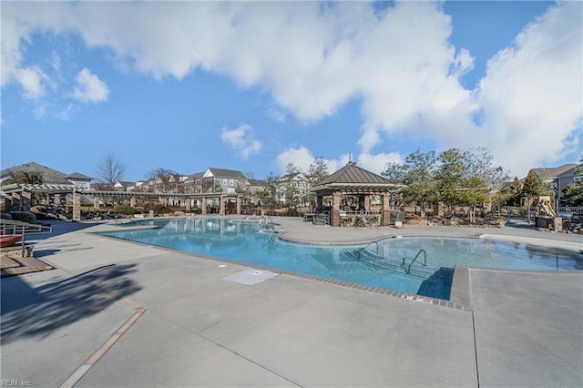 view of swimming pool with a gazebo and a patio